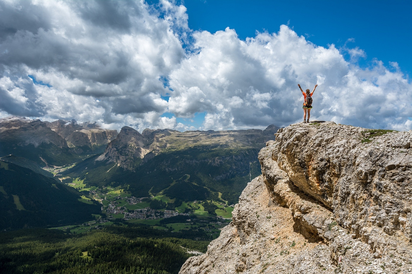 Bergsteigerin steht am Gipfel